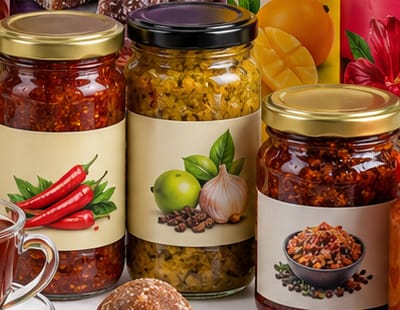 Glass jars of chilli sambol, lime pickle and mixed vegetable pickle.