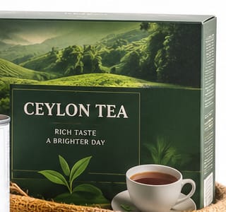 A carton of Ceylon tea with a freshly poured cup on a saucer.